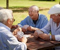 old men playing cards outside
