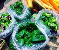 bagged spinach next to carrots