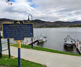 historical marker pointing out lake george's sunken fleet