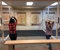 two women at axe throwing venue