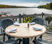 a table set up on a deck by water