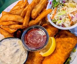 fish fry plate with coleslaw, sweet potato fries, and side of tartar sauce
