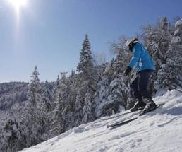 skier on mountain wearing a blue coat