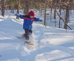 child snowshoeing