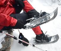 person putting snowshoes on