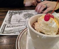 dessert in front of a Morgan & Co menu