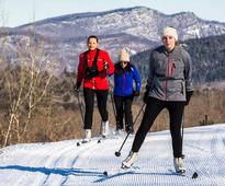 three people cross-country skiing at garnet hill