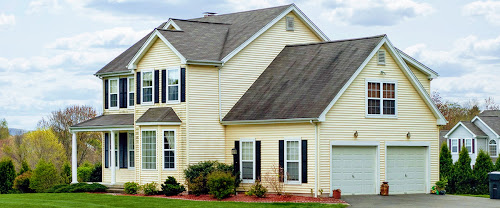 exterior of a home, yellow with black shutters and white trim
