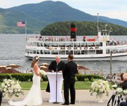 wedding ceremony with lake george steamboat company ship in the background