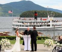 wedding ceremony with lake george steamboat company ship in the background