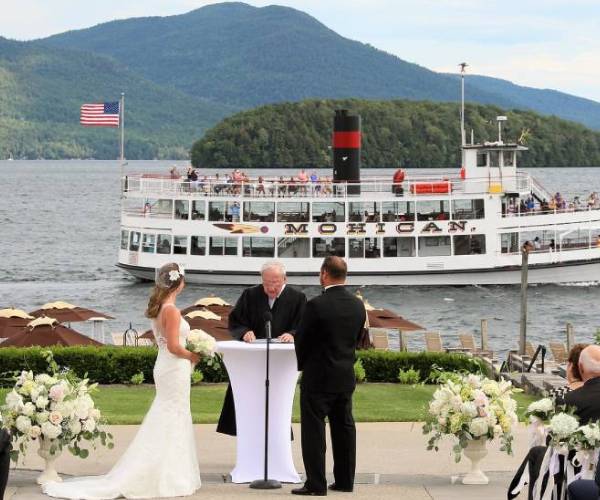 wedding ceremony with lake george steamboat company ship in the background