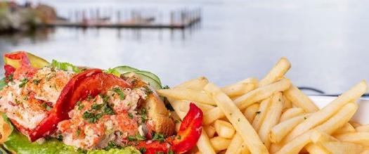 lobster rolls and fries with backdrop of lake and dock