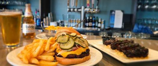 burger and fries on bar