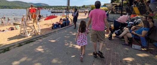 dad and daughter walk by million dollar beach