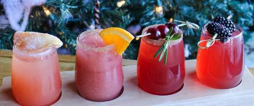 winter cocktail flight in front of christmas tree