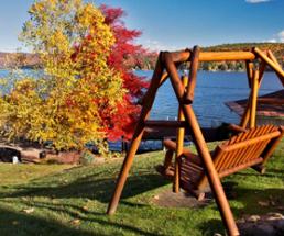 bench swing in front of fall scene at lake