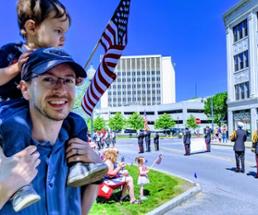 dad with son on his shoulders at memorial day parade