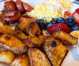 brunch plate with breakfast potatoes and fruit