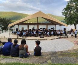 people watching band play in front of lake george