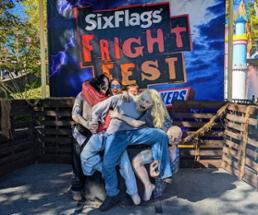 dad and son at fright fest photo op with fake zombies