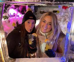 two women pose at ice bar