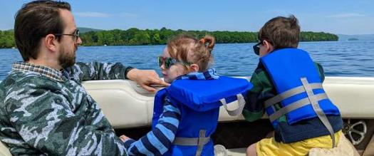 dad with two kids on boat