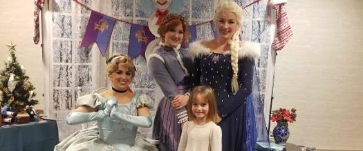 little girl poses with holiday princesses