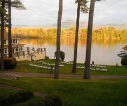 lake with foliage, chairs on lawn