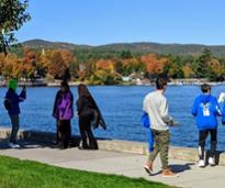people by lake george in fall