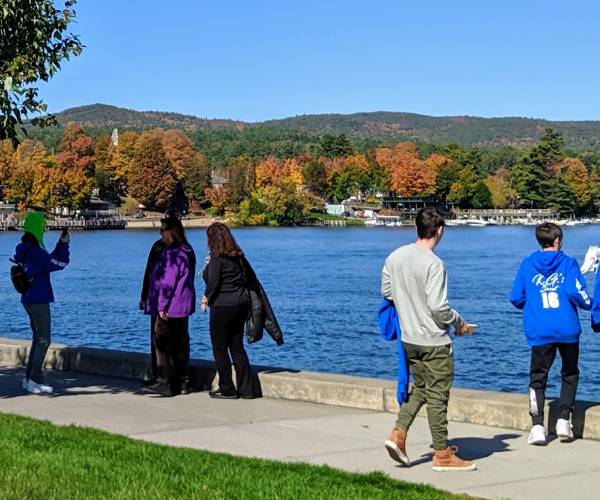 people by lake george in fall