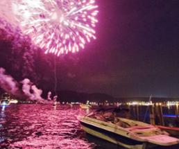 pink fireworks over a lake