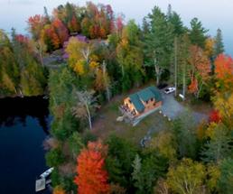 aerial view of vacation rental near water in the fall