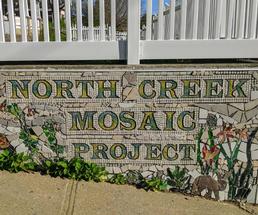 tile lettering that says North Creek Mosaic Project