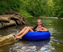 girl on a tube in a river