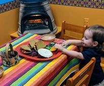 toddler at Mexican food exhibit in kids museum