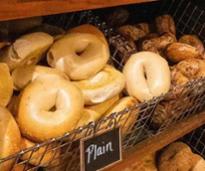 plain bagels on display in bakery