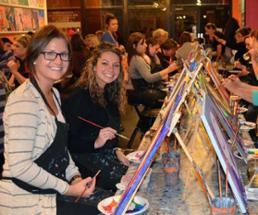women at paint and sip class