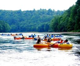 a large group of people river tubing