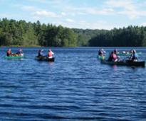 people in canoes on a lake