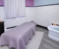 purple spa bed next to mineral bath tub