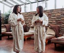 two women at a spa wearing robes