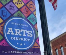 glens falls art district banner against a blue sky