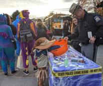 kid dressed up as a scarecrow trunk or treats