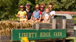 family on a hayride smiling