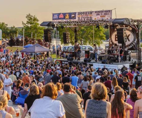 a huge crowd in front of a large stage