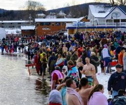 people standing by a lake for a polar plunge event