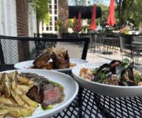 three plates of food on patio at park 26