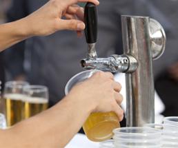 beer being poured into a cup from a tap