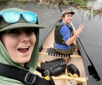 two women take a selfie on a kayak