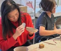 women making clay bowls